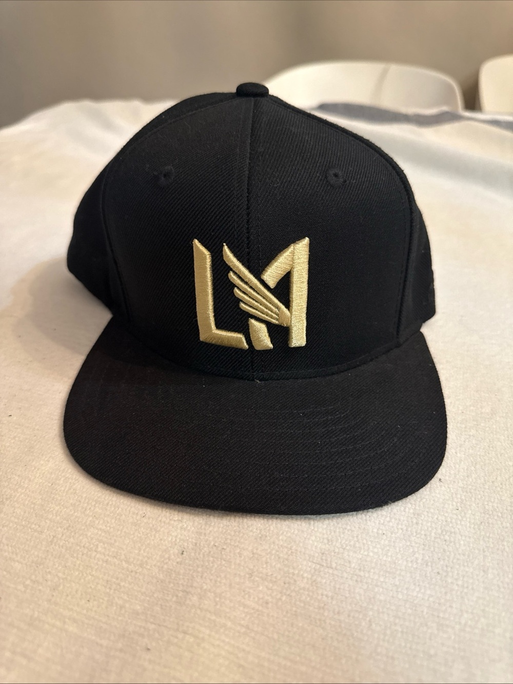 adidas Black and Gold LA Logo Hat with the day the start building the stadium